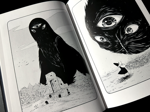 Photo: A black-and-white graphic novel opened to show two pages. On the left page, a giant, formless, shaggy, three-eyed being looms over the ruins of a stone building and a small person in a robe and pointed hat. On the right page, the face of the three-eyed thing has lowered to ground level, startling the small person, who now can be seen holding a wand. A vertical mouth is beginning to open on the giant face.